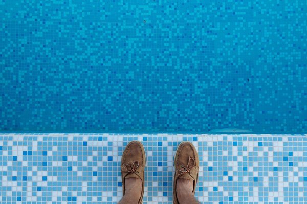 How should you adjust your pool maintenance schedule during the UK's summer season?